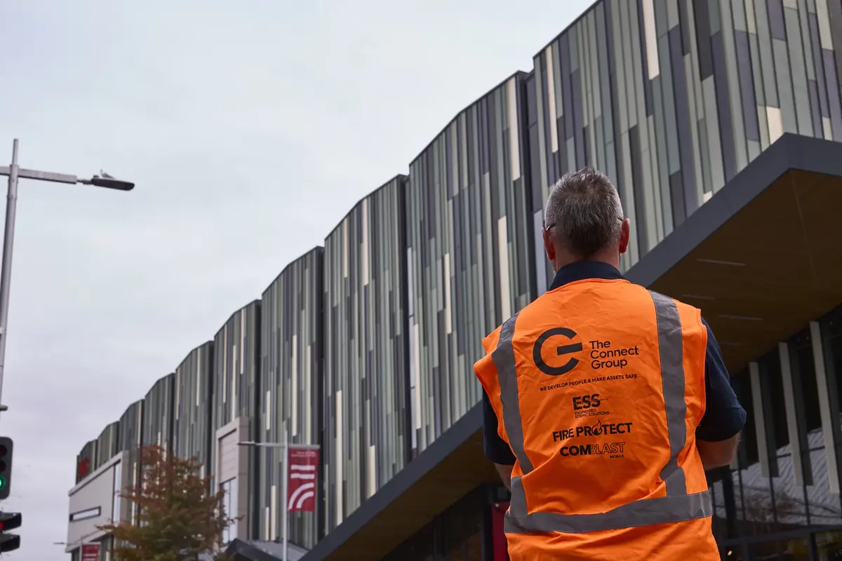 A Connect Group worker in a branded hi-vis vest on site