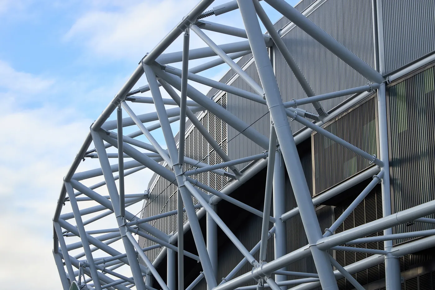 The stadium's curved white steel lattice framework